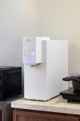 a white appliance sitting on a counter next to a microwave at Maritime Suites by Stellar ALV in Jelutong