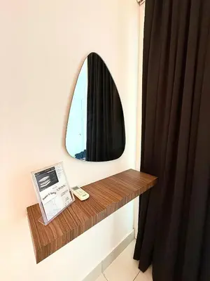 a bathroom with a mirror and a wooden table at Maritime Suites by Stellar ALV in Jelutong