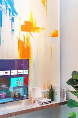 a living room with a tv on a shelf at Maritime Suites by Stellar ALV in Jelutong