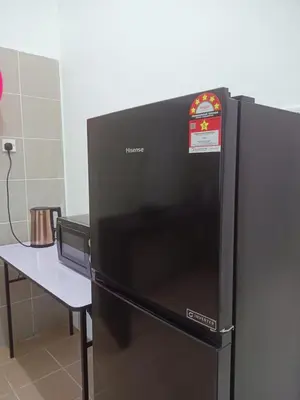 a black refrigerator with a sign on top of it at Double H Homestay in Tanjung Rambutan