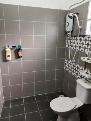 a bathroom with a toilet and a sink at Double H Homestay in Tanjung Rambutan