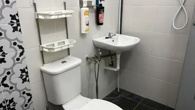a small bathroom with a toilet and a sink at Double H Homestay in Tanjung Rambutan