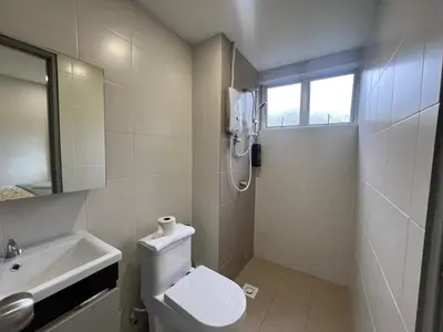 a white bathroom with a toilet and a sink at DanteQuintet Cameron Highlands in Tanah Rata