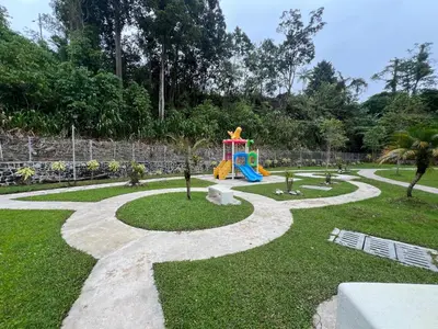 a playground with a slide in a park at DanteQuintet Cameron Highlands in Tanah Rata