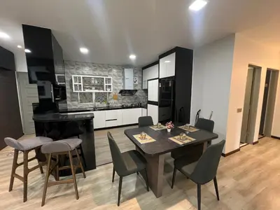 a kitchen with a table and chairs in a room at DanteQuintet Cameron Highlands in Tanah Rata