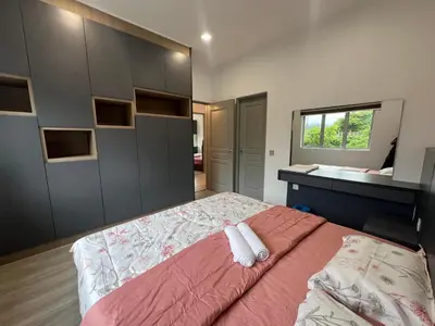 a bedroom with a large bed and a desk at DanteQuintet Cameron Highlands in Tanah Rata