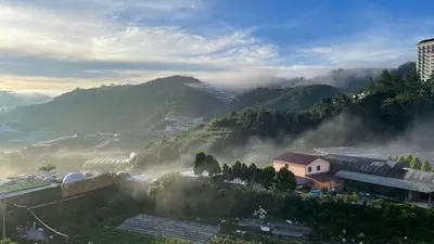a view of a valley with fog in the mountains at GreenValley in Brinchang