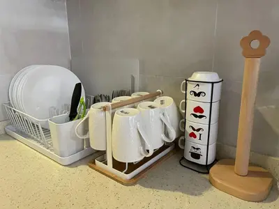 a kitchen counter with dishes and a drying rack at GreenValley in Brinchang