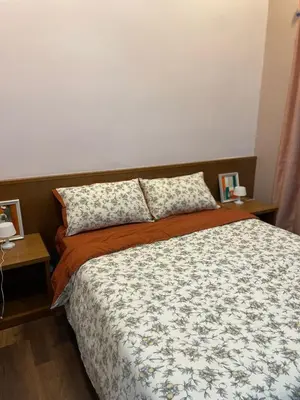 a bedroom with a bed with two pillows on it at GreenValley in Brinchang