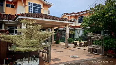 a house with a gate and a courtyard with a table at Homestay Santai Bertam in Kepala Batas