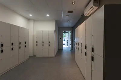an empty locker room with white lockers and a hallway at Resthub in George Town
