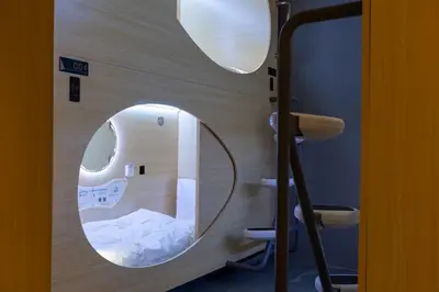 a room with a circular mirror on the wall at Resthub in George Town
