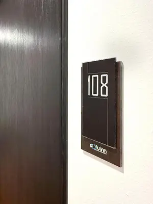 a clock on a wall next to a door at Sofu Inn in Jelutong