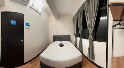 a bedroom with a bed in a room at Sofu Inn in Jelutong