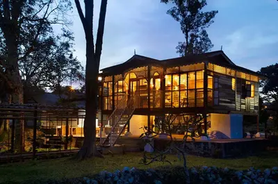 a large house with a staircase in front of it at Bagas Zakariah Orchard Lodge in Gopeng