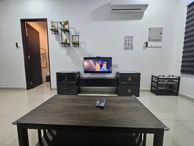 a living room with a tv and a table at V-Home Taiping, 3BR, 7pax, Full Aircond, Wifi & Netflix, Early Bird Promo in Taiping