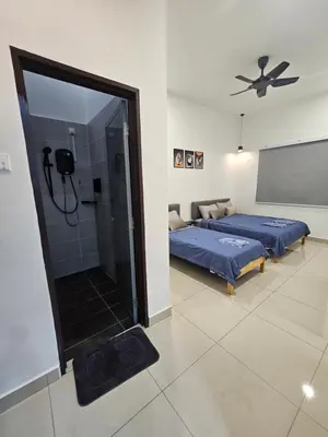 a bedroom with two beds and a shower in it at V-Home Taiping, 3BR, 7pax, Full Aircond, Wifi & Netflix, Early Bird Promo in Taiping