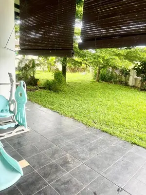 a patio with a blue bench and a grass yard at Hannah Homestay Ipoh in Ipoh