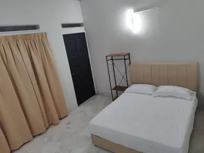 a bedroom with a bed and a black door at Homestay 39 Private Pool Perak in Tanjung Rambutan