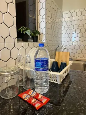 a bottle of water sitting on top of a counter at Rimbunan Padi Roomstay in Bagan Serai