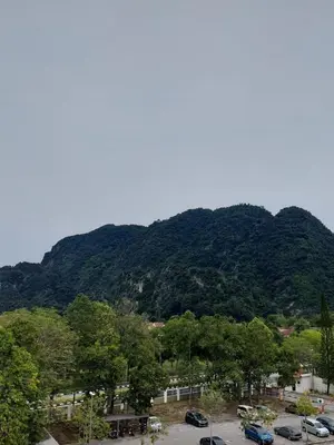 a mountain with cars parked in a parking lot at Alle Vacation Homes Tambun Ipoh in Ipoh