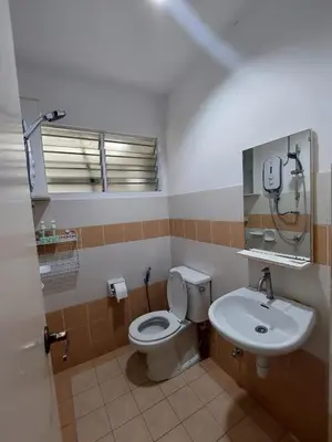 a bathroom with a toilet and a sink at Alle Vacation Homes Tambun Ipoh in Ipoh