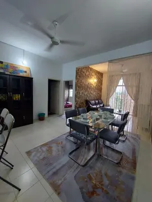 a living room with a table and chairs at Alle Vacation Homes Tambun Ipoh in Ipoh