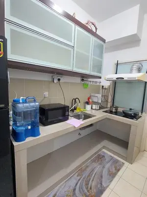 a kitchen with a sink and a counter top at Alle Vacation Homes Tambun Ipoh in Ipoh
