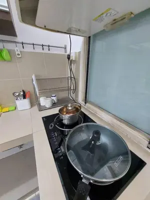 a kitchen stove with a pot on top of it at Alle Vacation Homes Tambun Ipoh in Ipoh