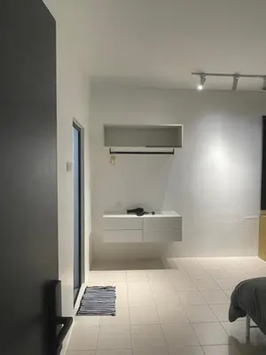 a white bathroom with a sink on a wall at 39 Haus in Bukit Mertajam