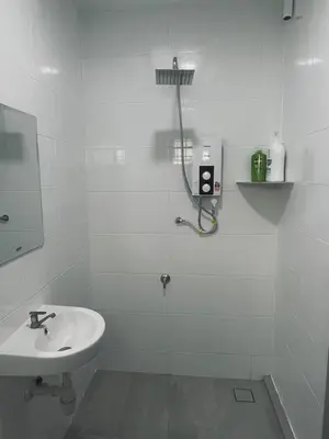 a white bathroom with a sink and a shower at 39 Haus in Bukit Mertajam