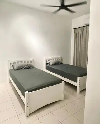 two beds in a bedroom with a ceiling fan at 39 Haus in Bukit Mertajam