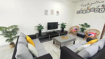 a living room with a couch and a tv at 33 HOMESTAY 4 Room 5 MINUTE TO LEANING TOWER in Teluk Intan
