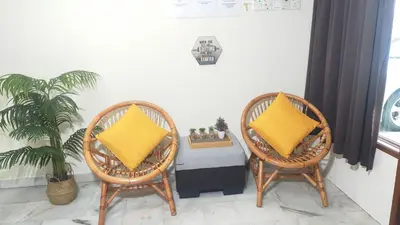 two wicker chairs with yellow pillows in a room at 33 HOMESTAY 4 Room 5 MINUTE TO LEANING TOWER in Teluk Intan