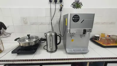 a kitchen counter with a mixer and a pot on a stove at 33 HOMESTAY 4 Room 5 MINUTE TO LEANING TOWER in Teluk Intan