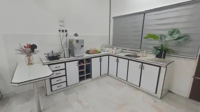 a kitchen with white cabinets and a sink at 33 HOMESTAY 4 Room 5 MINUTE TO LEANING TOWER in Teluk Intan