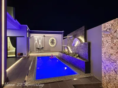 a house with a swimming pool at night at Moon22 Private Pool in Ipoh