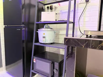 a purple shelf with a blender on it next to a refrigerator at Moon22 Private Pool in Ipoh