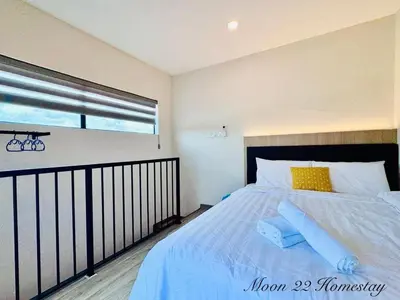 a bedroom with a large bed and a window at Moon22 Private Pool in Ipoh
