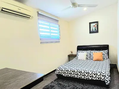 a bedroom with a bed and a window at 1813 HOME STAY 8 Roon 6 Bath 5MINUTE TO LEANING TOWER in Teluk Intan