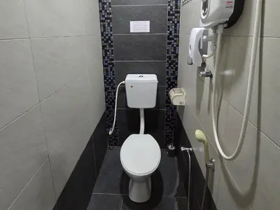a bathroom with a white toilet in a stall at 1813 HOME STAY 8 Roon 6 Bath 5MINUTE TO LEANING TOWER in Teluk Intan