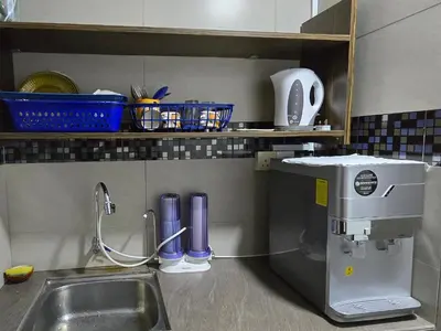 a kitchen counter with a sink and a mixer at 1813 HOME STAY 8 Roon 6 Bath 5MINUTE TO LEANING TOWER in Teluk Intan