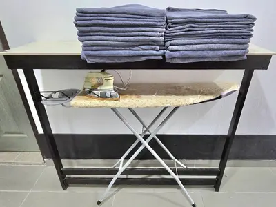 a table with purple towels on top of it at 1813 HOME STAY 8 Roon 6 Bath 5MINUTE TO LEANING TOWER in Teluk Intan