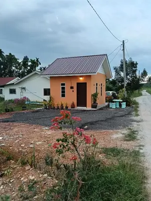 a house with a gravel driveway in front of it at D'Permata Roomstay Kampung Pelet in Kubang Semang