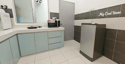 a kitchen with a sink and a refrigerator at Natural Garden Stay in Cameron Highlands in Tanah Rata