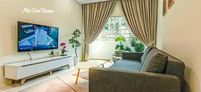 a living room with a couch and a flat screen tv at Natural Garden Stay in Cameron Highlands in Tanah Rata