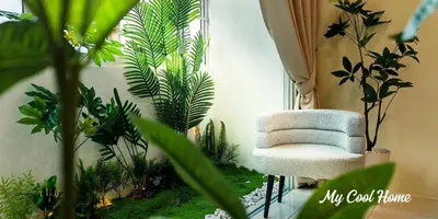 a chair sitting in a room with plants at Natural Garden Stay in Cameron Highlands in Tanah Rata