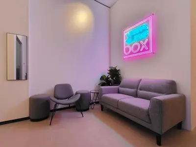 a waiting room with a couch and two chairs at TREASURE BOX At Heritage Georgetown in George Town