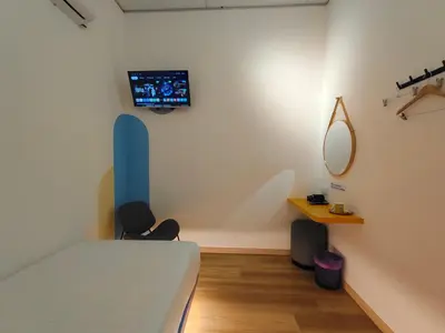 a bedroom with a bed and a tv on a wall at TREASURE BOX At Heritage Georgetown in George Town