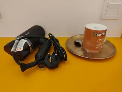 a table with a cup of coffee and headphones at TREASURE BOX At Heritage Georgetown in George Town